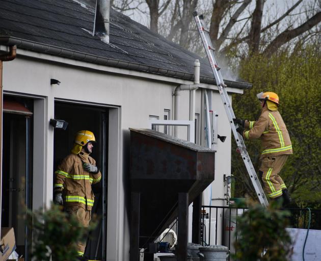 Firefighters at the scene of a house fire in Bainfield Rd. Photo: Laura Smith