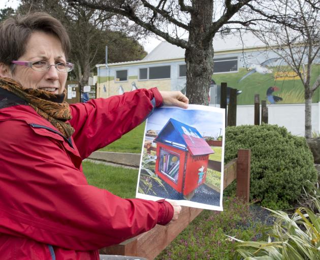 Lilliput Library founder Ruth Arnison holds a photograph of the Rotary Park Kindergarten Lilliput...