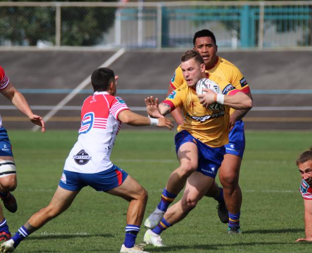 North Otago centre Hayden Todd has prop Kelepi Funaki in support as he looks to fend Horowhenua...