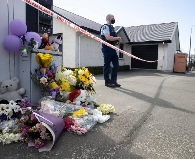 The public have begun leaving flowers and teddies outside a Queen St, Timaru house where the bodies of three young sisters were found on Thursday. Photo: George Heard