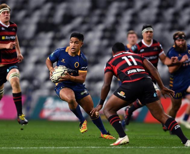 Otago first five-eighth Josh Ioane looks to sidestep Canterbury winger Manasa Mataele during the...