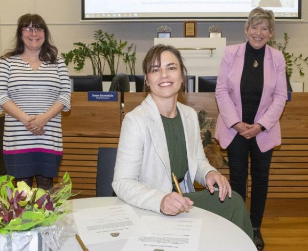 Celeste Donovan signs her Declaration of Office with council chief executive Dawn Baxendale and...