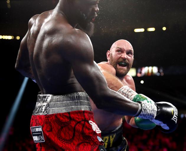 Tyson Fury (right) landed a flurry of punches in the 11th round, finally knocking out Deontay...