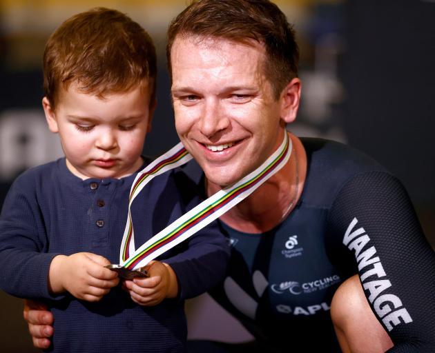 Aaron Gate has his silver medal admired by son Axel at the world track cycling championships in...