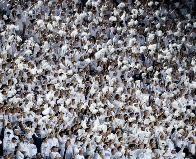Members of the Penn State student section cheer their team against the Indiana Hoosiers in...