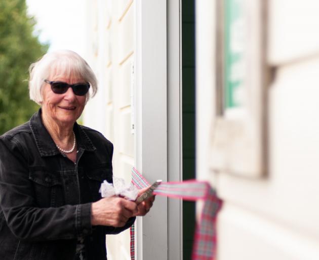 Ruth McNamara cuts the ribbon to officially open the Lauder Railway Station building on Saturday....