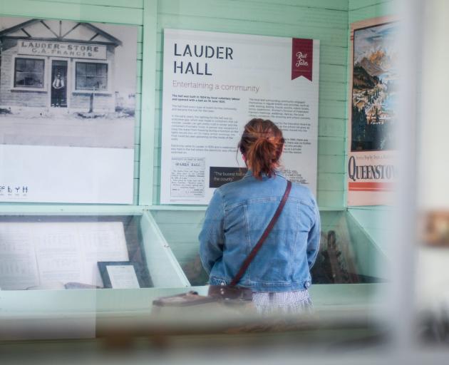 Jess Armstrong, of Heritage NZ, reads history panels in the newly opened Lauder Railway Station.