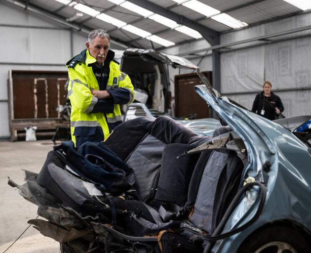 Inspector Dave Gaskin looks over the car, which was ripped in half by the impact of a crash in Timaru which left five boys dead. Photo: NZ Herald