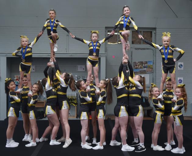 Team members from Eclipse Cheerleading’s elite level 1 squad Aurora and elite level 2 squad Lady...