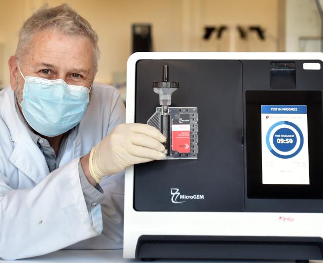 MicroGEM chief scientific officer Dr David Saul shows the Covid-19 saliva test which the business...