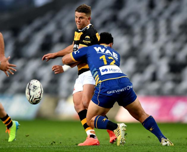 Taranaki second five-eighth Tei Walden is tackled by Otago's Ray Nu'u during tonight's NPC game...