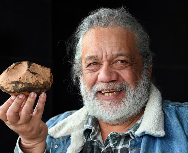 Miner and geologist Harry Albert, of Milton, holds what he believes may be a meteorite,...