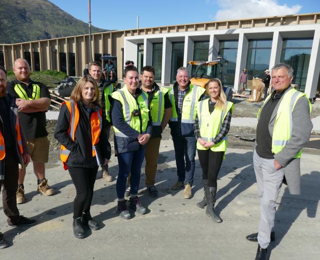 In front of the nearly-complete Southern Cross CLT hospital are (from left) architect Tomasz...