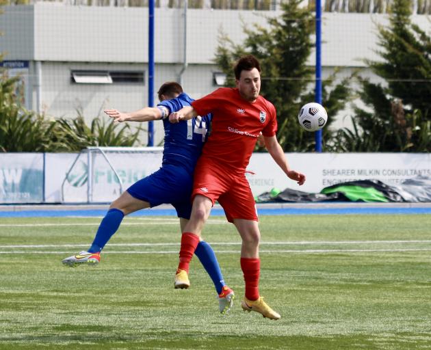 outh City Royals midfielder Olivier Cassidy (front) goes up for the ball with Christchurch United...