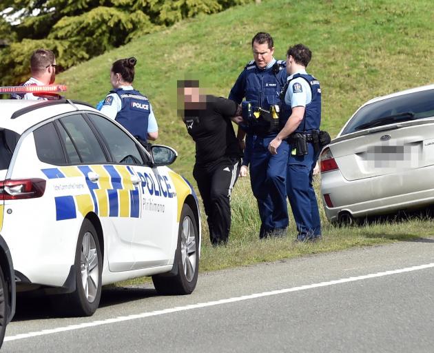 A man is arrested at the side of State Highway 1, south of Waitati, yesterday about 4pm. PHOTO:...