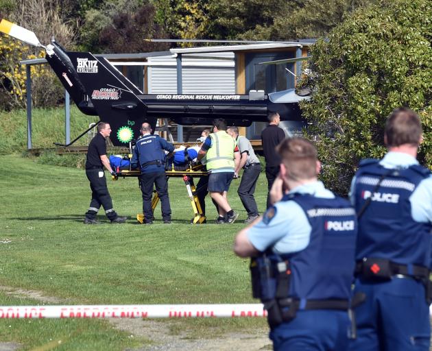 Emergency services transfer a patient in a critical condition to a waiting helicopter in Coast Rd...