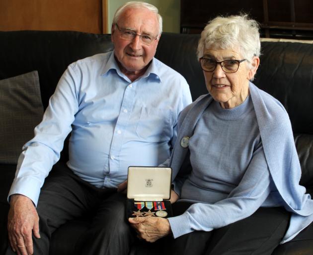 Genevieve Hanning (nee Newman) shows her uncle Herb Newman?s medals, seated next to her husband...