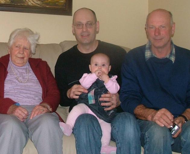 Darin Paterson (middle) with his dad, Bruce, in a family photo spreading across four generations....