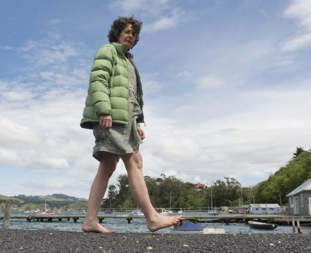 Climate protester Nicola Chapman walks through Port Chalmers in her bare feet yesterday. PHOTO:...