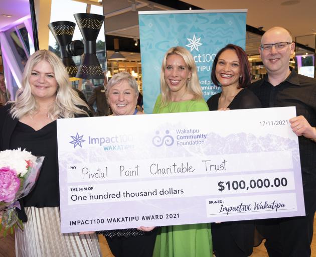 Holding a $100,000 cheque to help neurodiverse children and children with learning disorders are ...