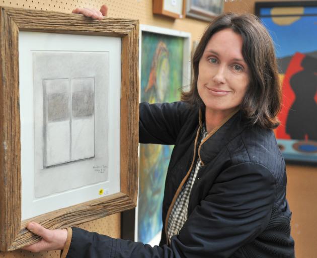 Hayward’s Auction House co-owner Bridgette More holds Ralph Hotere’s Window in Spain, which is up...