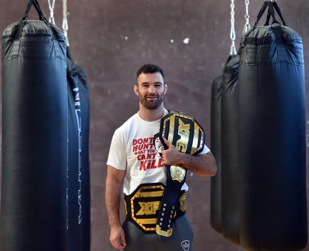 Dunedin MMA fighter Brogan Anderson relaxes with his belts a the Olympic Gym after claiming his...