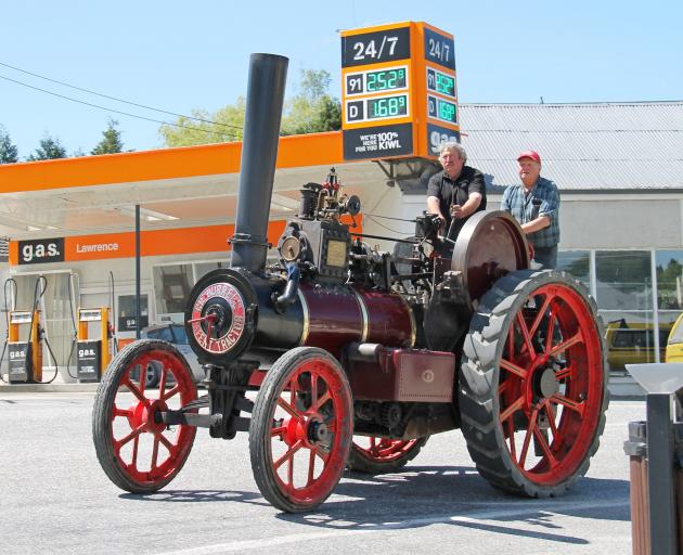 Tractor drivers Geoff Henderson (left) and Stuart McCraw steer a vintage tractor through Lawrence...