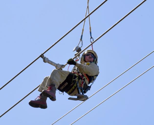 Contractor Gene Peters works on transmission lines in the Grebe Valley, near Manapouri. PHOTOS:...