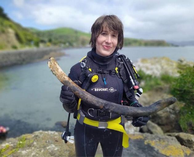 Dive Otago student Charlotte Goodyear holds a whale bone she found near Wellers Rock, in Otago...