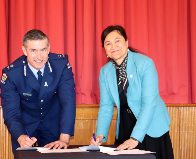 Police Commissioner Andrew Coster and Te Runanga o Ngai Tahu chief executive Arihia Bennet sign a...