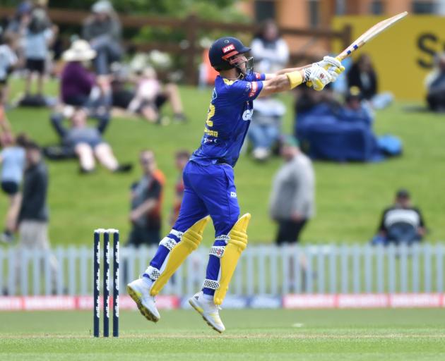 Otago batsman Hamish Rutherford smacks the ball for six to bring up his half-century against...