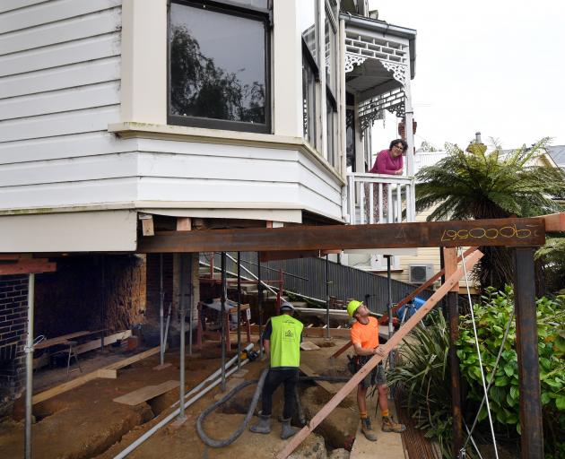 Valeri Schillberg chats to the workers below at her Tweed St villa as Dunedin Concrete concrete...