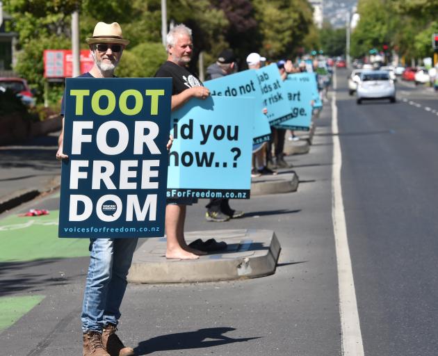 Vaccine mandate protesters stand opposite the North Ground on SH1 on Saturday morning. PHOTO:...
