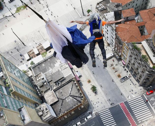 A base jumper leaps from the 28-floor Martinelli Building in Sao Paulo, Brazil. PHOTO: REUTERS
