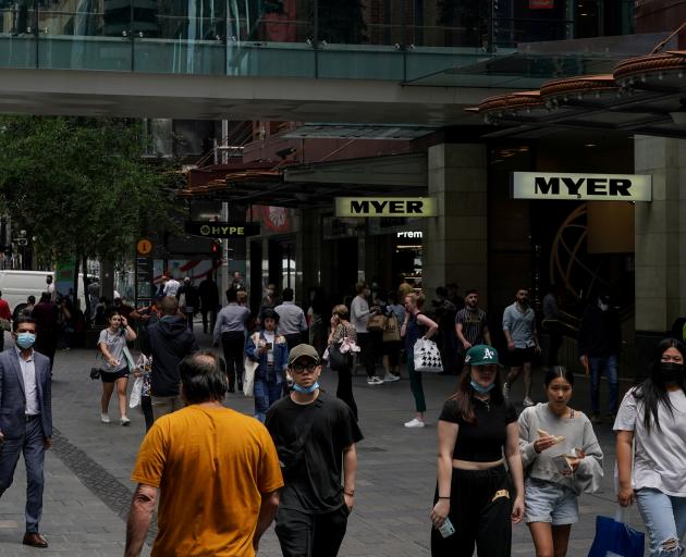 People walk through a shopping plaza in the centre of Sydney. Photo: Reuters