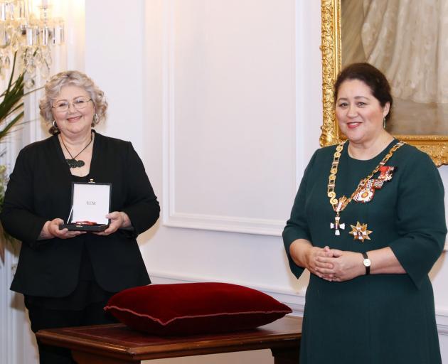 Tracey Wright-Tawha, of Invercargill, receives the Member of the New Zealand Order of Merit medal...