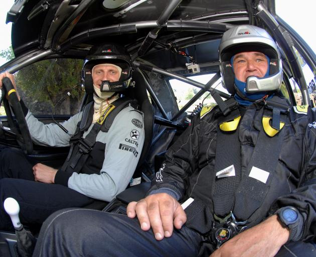 New Zealand rowing great Hamish Bond (left) and co-driver Grant Marra go for a drive in...