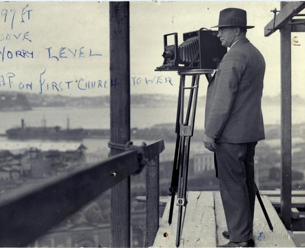 Dunedin photographer E. A. Phillips takes in the view standing on scaffolding surrounding First...