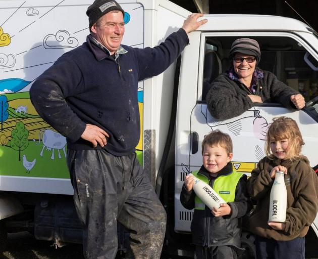 John Marshall and Anna Emmerson and their children Max, 4, and Georgie, 6, with their "Moo Juice"...