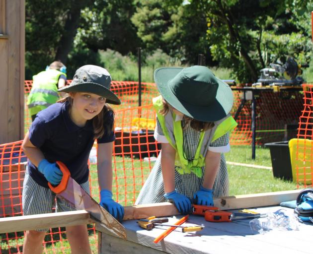 Aria on the saw helping out with the tree huts in the Avon Ōtākaro River Corridor. Photo: Supplied