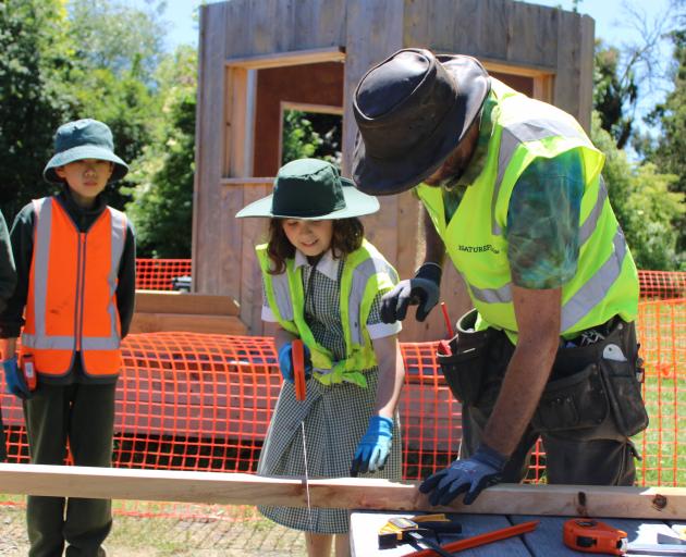 Ella helping out with the saw. Photo: Supplied