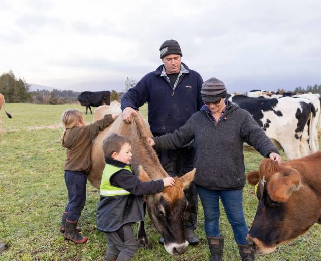 Long-time farmers Anna Emmerson and John Marshall out on the farm with their two children Georgie...