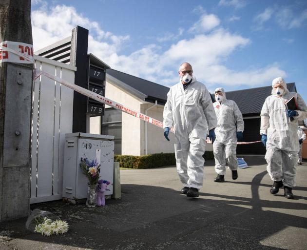Police at the scene of the alleged triple murder. Photo: George Heard
