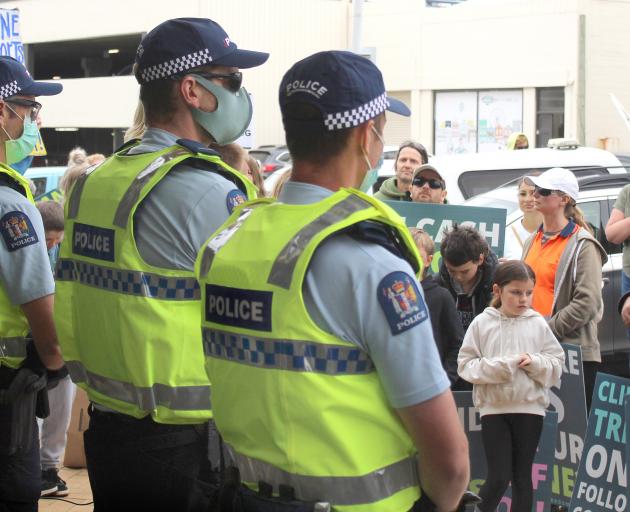 Police protect the Invercargill City Council entrance as anti-vaccine mandate protesters gather...