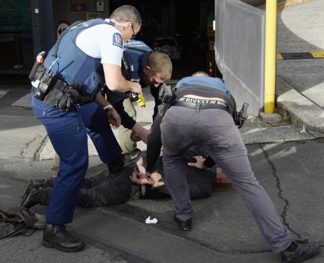 Mark David Cummings is subdued by police after he smashed up the Dunedin City Council reception...