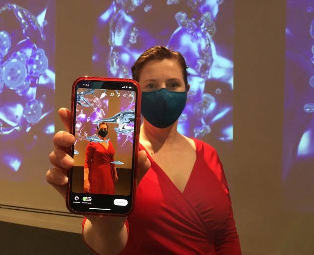 Otago Museum marketing manager Kate Oktay demonstrates the sort of immersive, augmented reality...