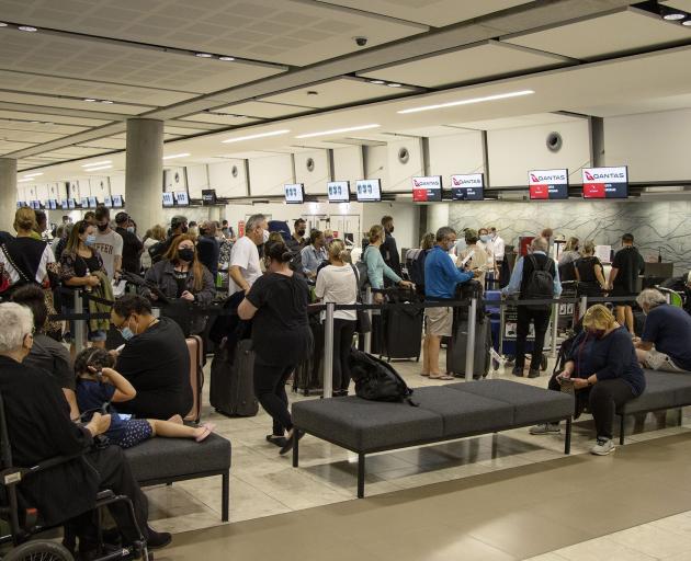 Passengers line up at Christchurch Airport yesterday to check in for Vincent George Travel’s...