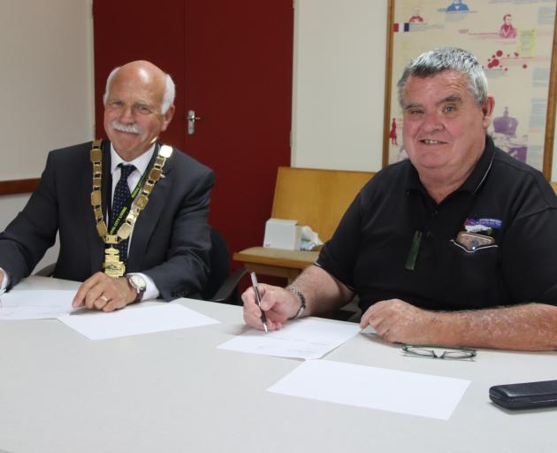 Gore Mayor Tracy Hicks (left) and Hokonui Runanga executive vice-chairman Terry Stott sign a...