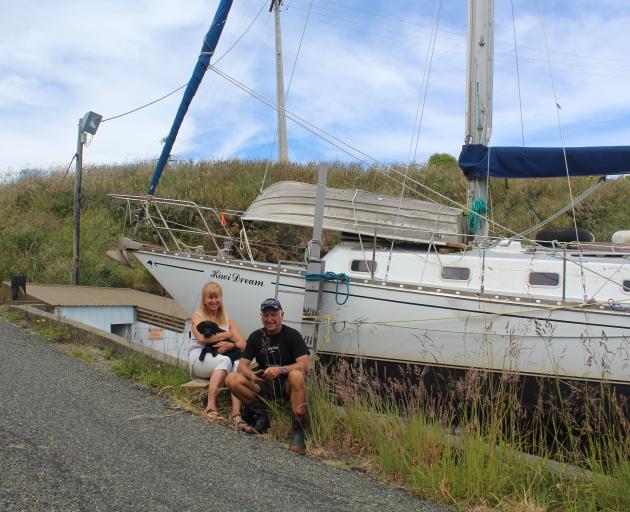 Sailors Anne Pilcher-Gough, holding puppy Tess, and Alan Forrest, of Riverton, showcase their...