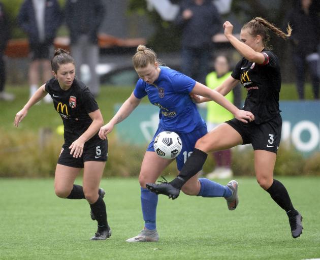 Southern United forward Amy Hislop looks to control the ball as Canterbury United defenders...